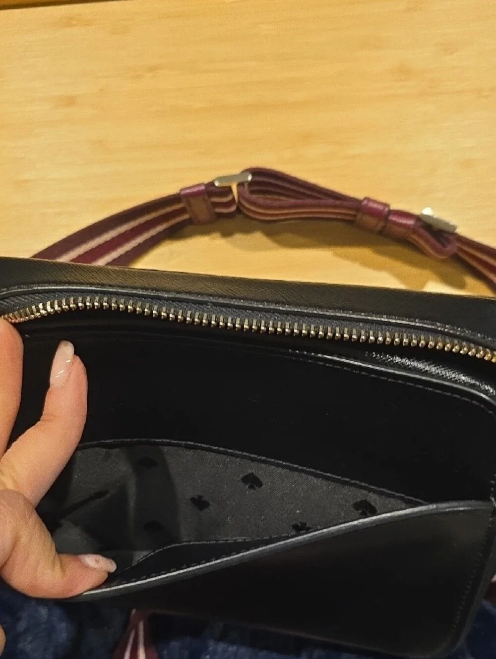 kate spade Lauryn black leather camera bag with burgundy striped strap